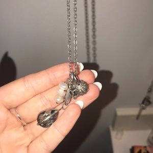 Long silver necklace with charms on end